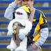 A Michigan fan watches from the stands during the Victors Classic alumni football game at Michigan Stadium on Saturday. Melanie Maxwell I AnnArbor.com